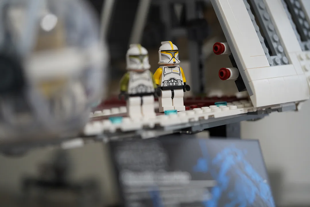 Two Lego clone trooper figures standing on the ramp of a model ship, photographed close with the background thrown out of focus